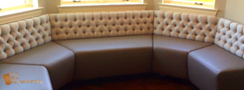Curved banquette in chocolate leather — upholstered by M&M Upholstery, Dallas