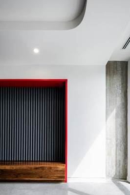 Banquette against a red wall — upholstered by M&M Upholstery, Dallas