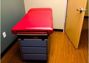 Examination table in red vinyl — upholstered by M&M Upholstery, Dallas